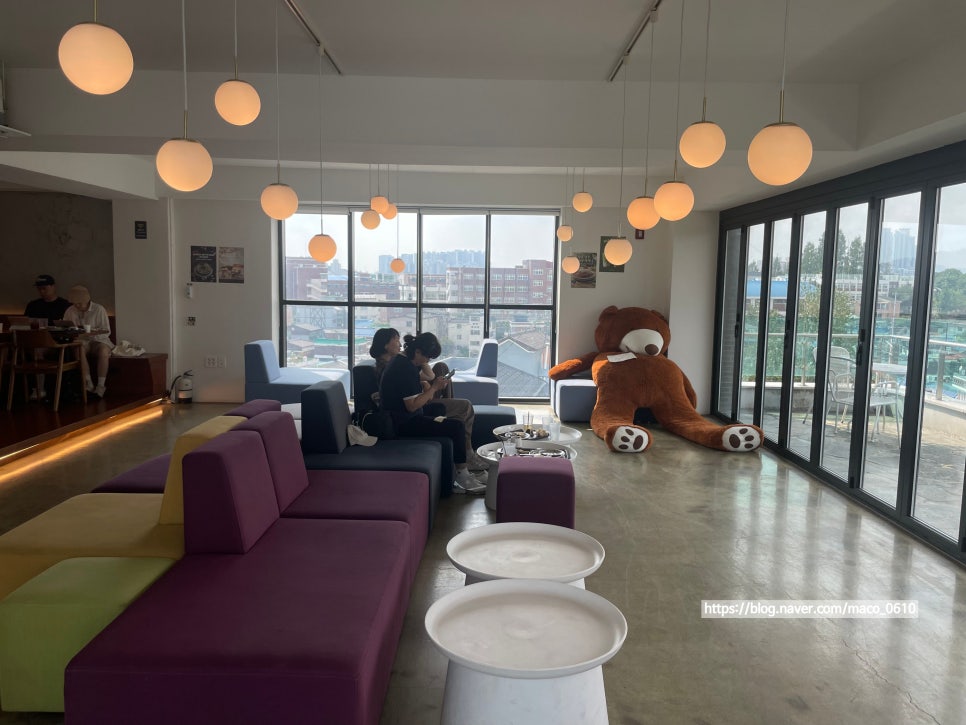 Upper-floor lounge with large windows and rooftop access